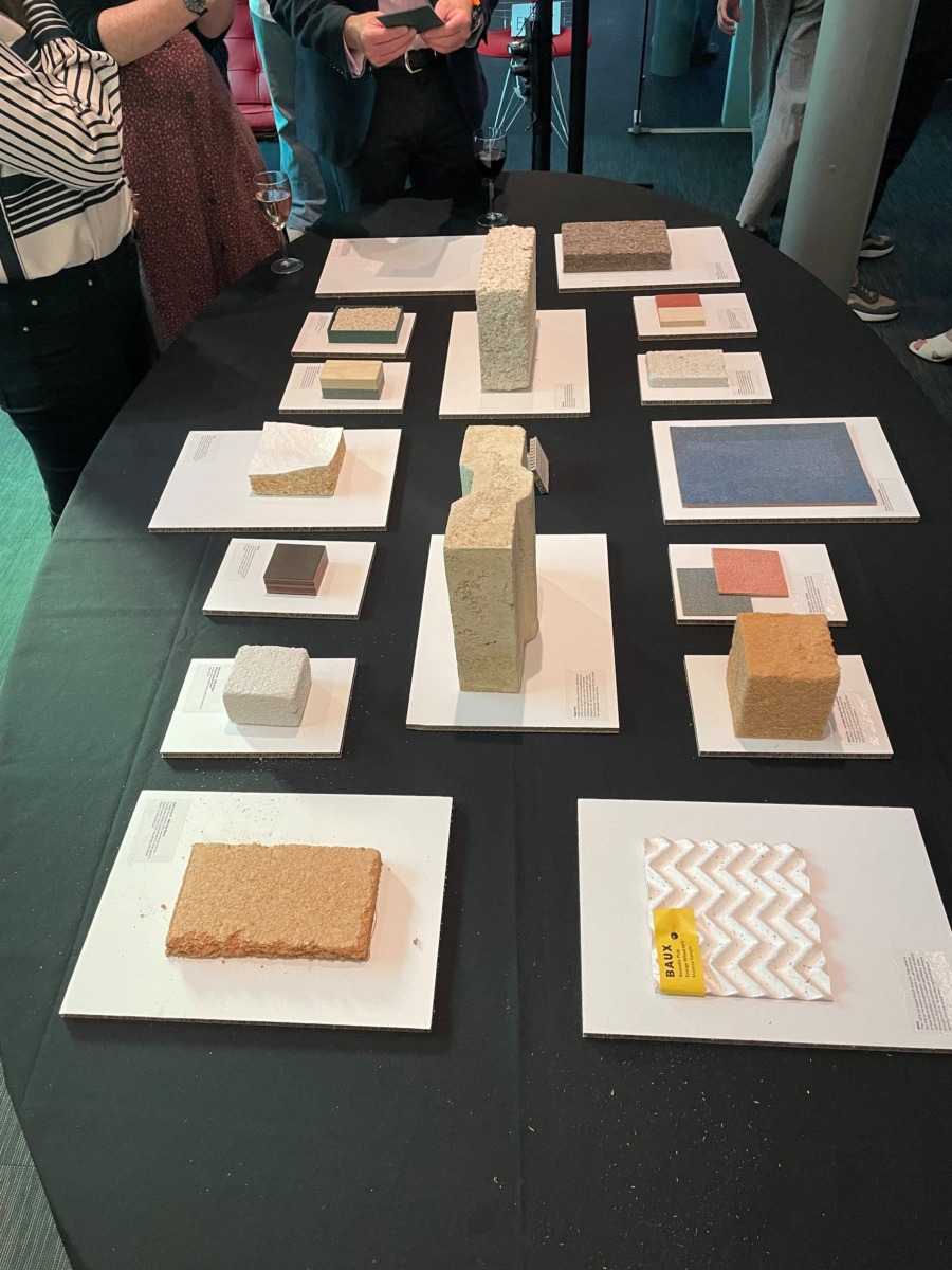 Small pieces of different coloured blocks sit on white boards on a black table